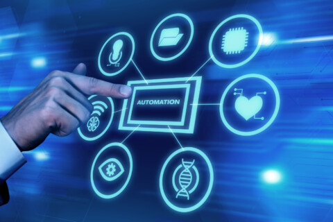 Hand pointing to a digital interface displaying interconnected automation icons including AI, data, DNA, and wireless signals, representing hyperautomation and smart data insights in startups.