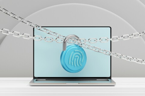Laptop display secured by chains and a blue fingerprint lock, symbolizing AI-powered cybersecurity and digital protection.