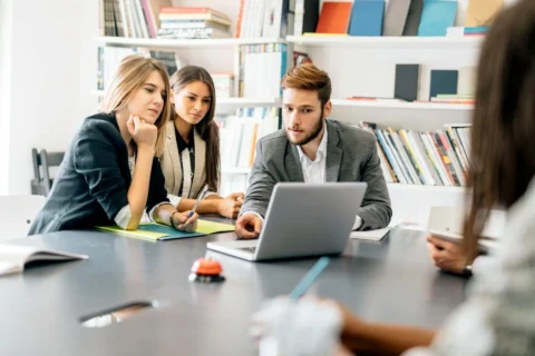 Solo founder and small team collaborating on laptop for workflow automation